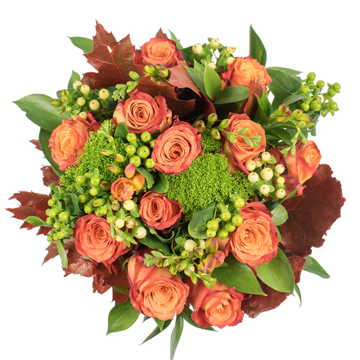 From a clean overhead view this richly textured autumn bouquet presents itself like a small harvest captured in floral form, a design you might find being prepared by Florist Tolworth for a Tolworth evening table. The arrangement is densely circular, anchored by many large roses whose petals graduate from a soft, warm peach at the hearts to coral-orange and finally to deeper russet and reddish-rust along the outer petals, creating a layered, living gradient. Interspersed between the roses are smooth Hypericum berries - some vivid lime green, some pale cream - which add bright punctuation and a crisp, almost tactile contrast. Bright-green Green Trick dianthus appears as plush, moss-like tufts, lending a playful, verdant texture that lifts the composition and echoes the softness of nearby park lawns on an autumn day. Rich, lobed leaves in deep burgundy and brown are artfully placed to evoke fallen leaves, while glossy green foliage provides a lush, supporting backdrop that makes the colours sing. Gentle, diffuse light reveals the velvety surface of the roses and the glossy finish of the berries, while faint shadows give dimension and warmth. The overall impression is one of abundant comfort - a seasonal centrepiece for harvest meals, a thoughtful gift for birthdays or housewarmings, or a simple way to bring the warm colours of the season into a home by the A3 or along Ewell Road. The bouquet feels both hand-crafted and effortlessly natural, designed to read beautifully in photographs or arranged on a candlelit table.